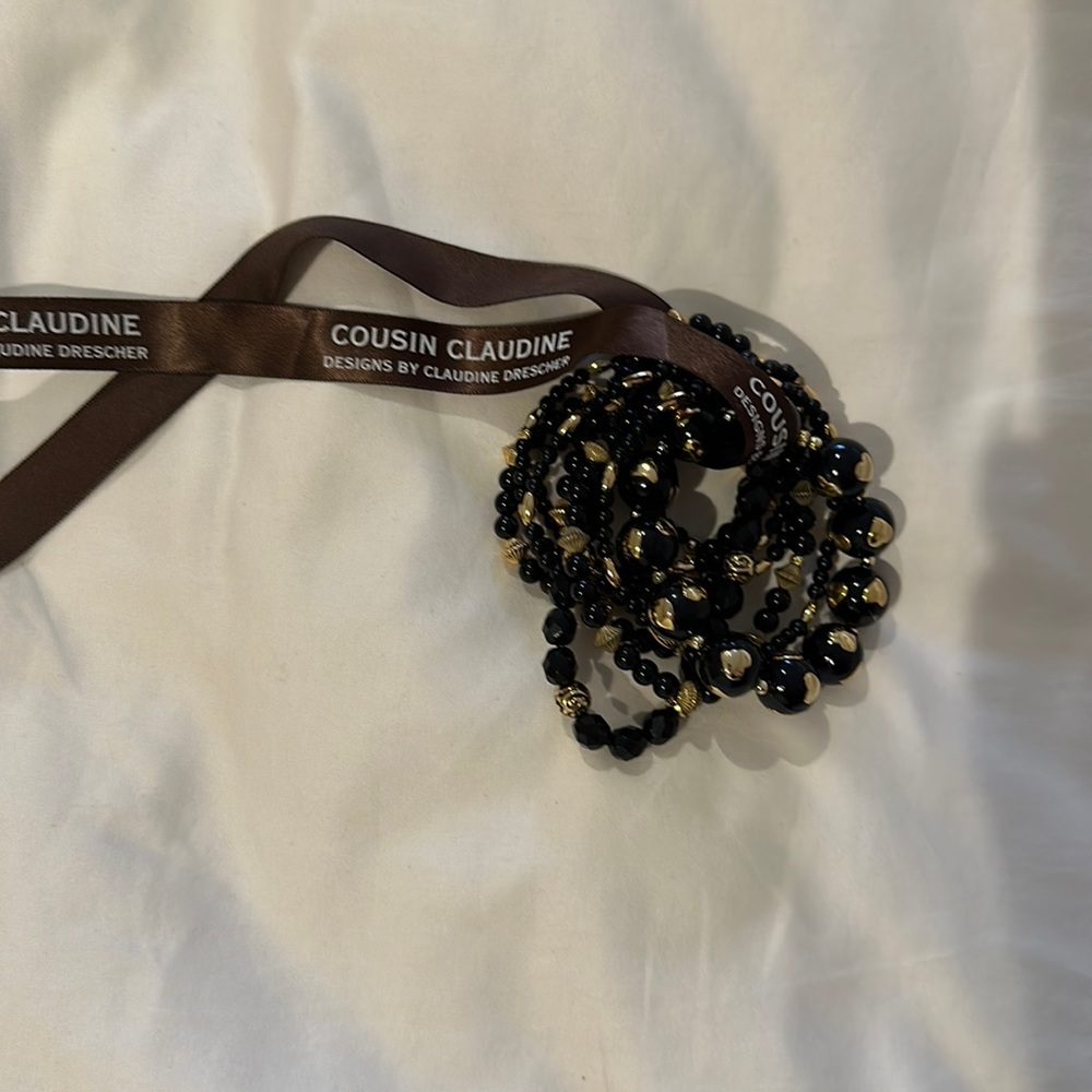 Cousin Claudine black and gold beaded bracelet set. 9 pieces.